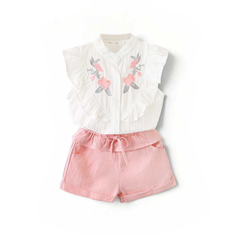 BabyEase Blossom & Ruffle set featuring a white embroidered blouse with cascading ruffles and pink linen shorts.