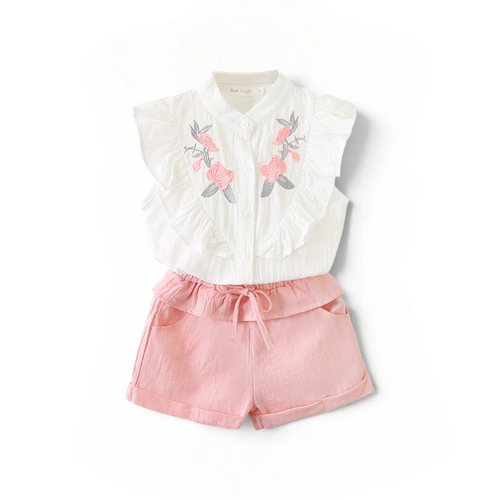 BabyEase Blossom & Ruffle set featuring a white embroidered blouse with cascading ruffles and pink linen shorts.