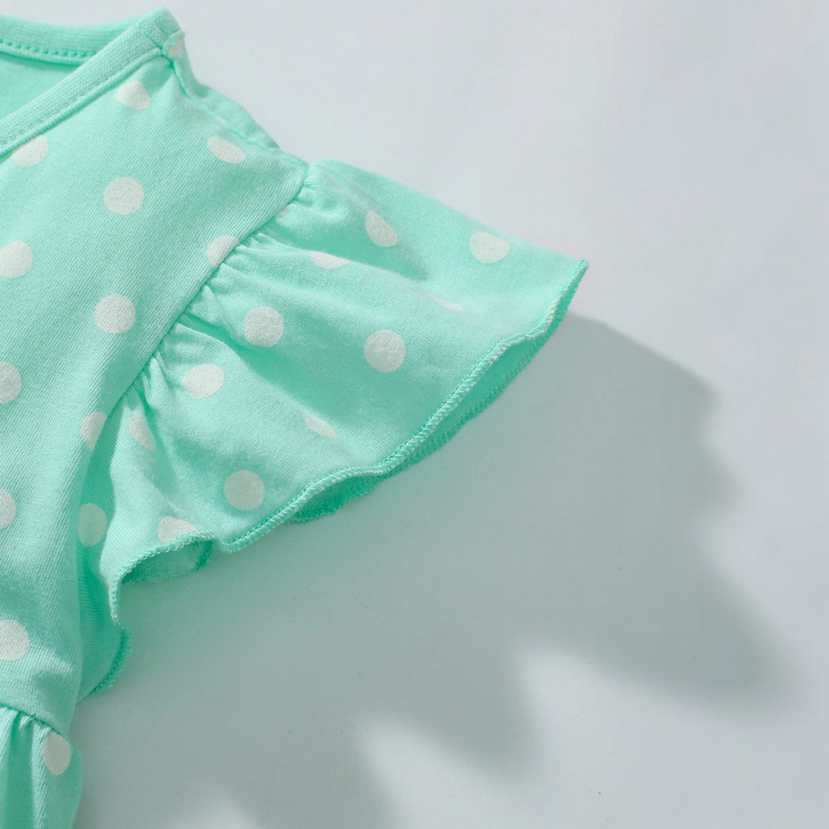 BabyEase mint green polka dot tunic top with flutter sleeves and safari animal print detail